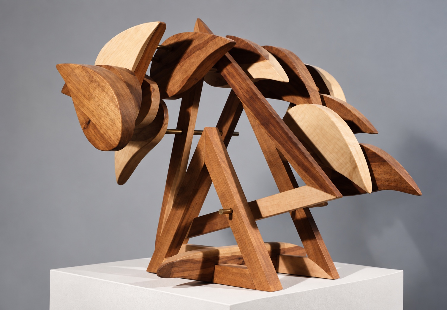 Wooden sculpture with broad sweeping curves, overlapping forms, and triangular supports on a pedestal