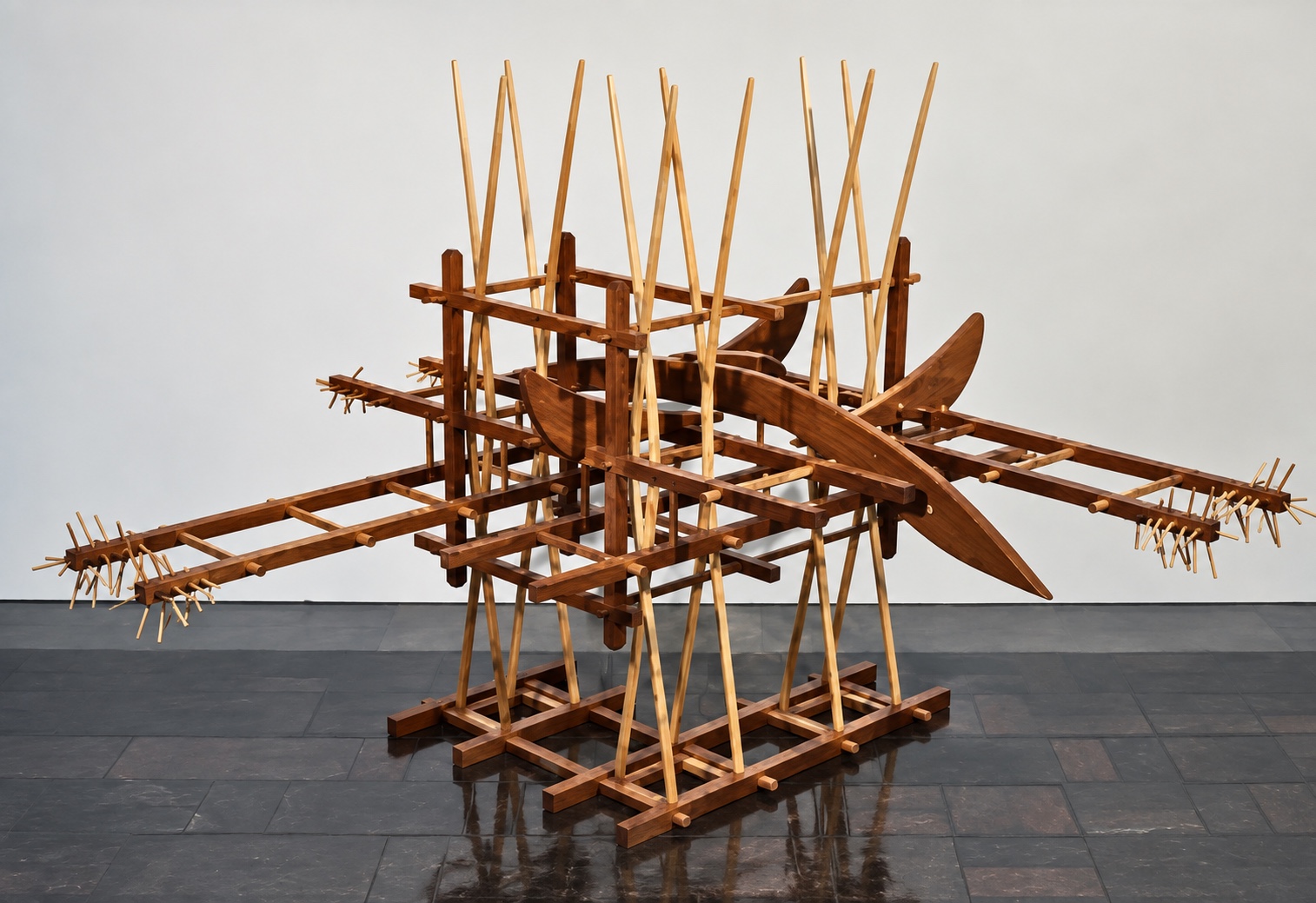 Wide wooden sculpture with projecting horizontal elements, tall pointed forms, and layered curves