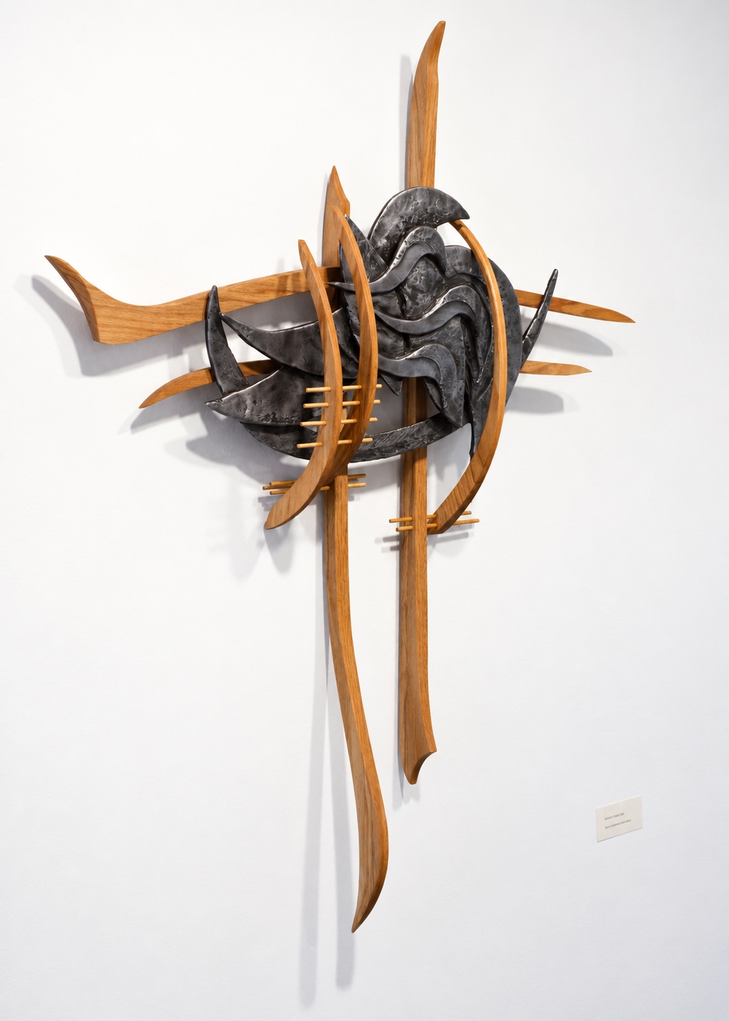 Organic wood and cast sculpture with sweeping curves and overlapping wave-like forms