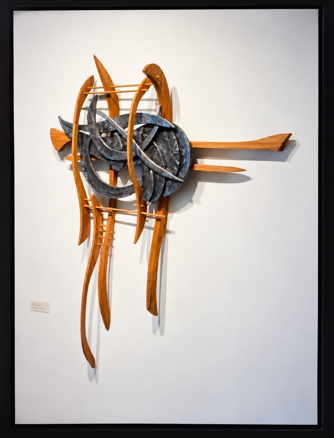 Organic wood and cast sculpture with curled, interwoven forms and long curved wooden elements
